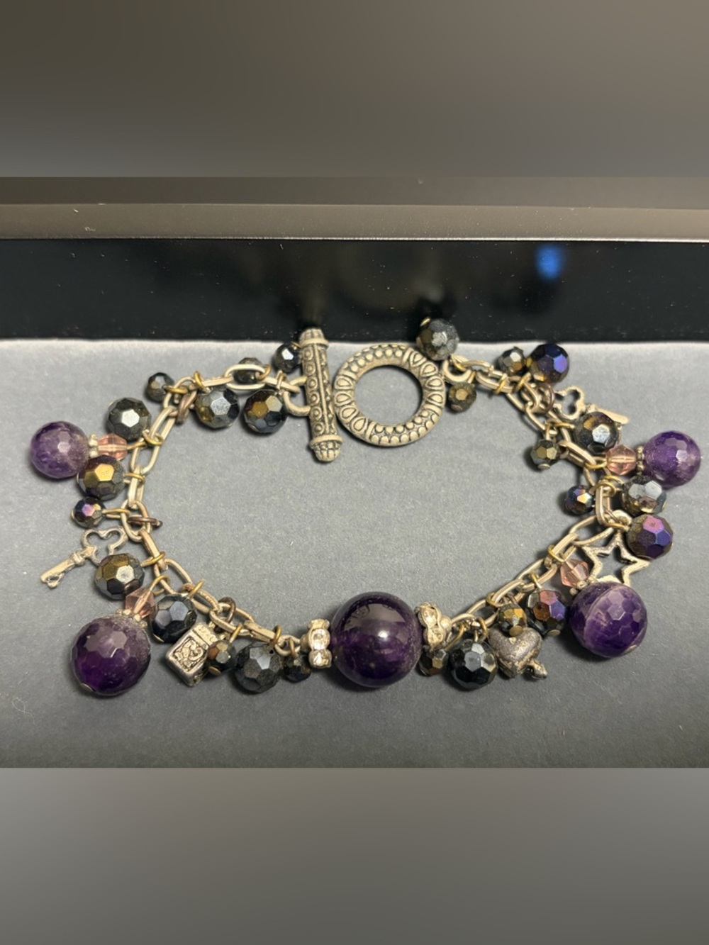 Vintage Charm: Silver-Tone Bracelet with Purple Gems, Beads and Charms